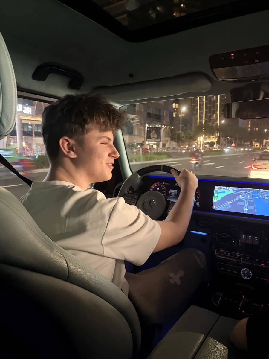 Thomas au volant, le soir, en ville